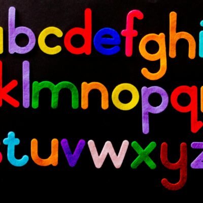 Vibrant alphabet letters arranged against a dark background for educational use.